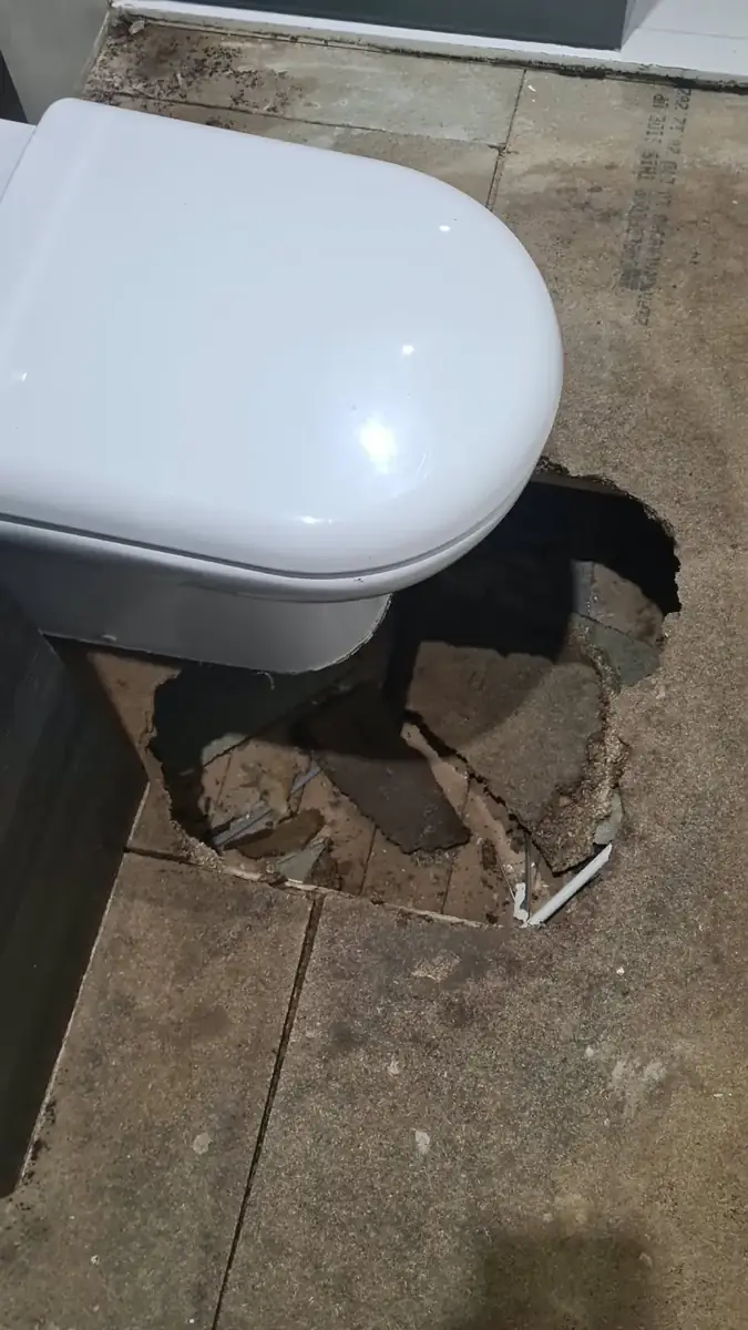 Floor repair area beside the toilet
