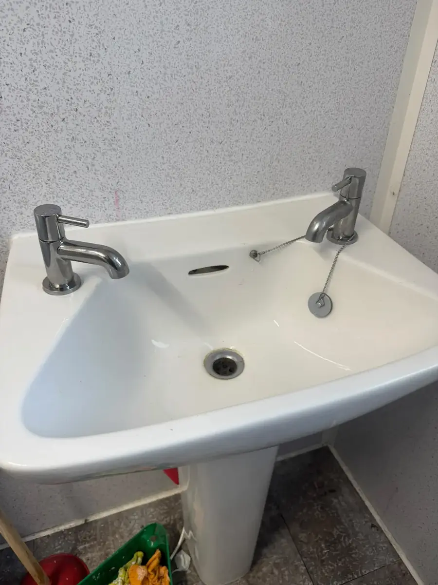 Basin with chrome lever taps
